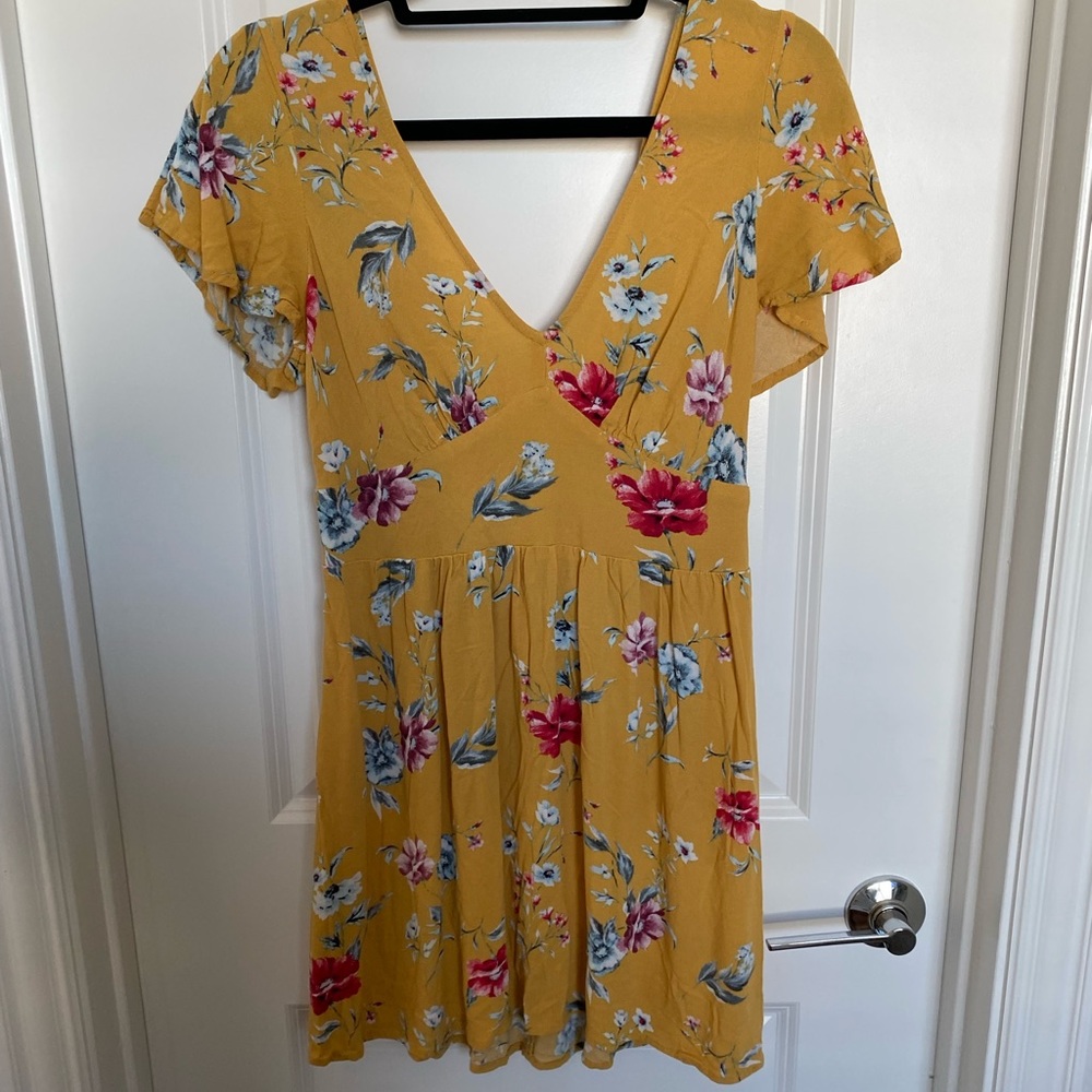 V cut, yellow patterned dress with flowers on it, size M only worn once